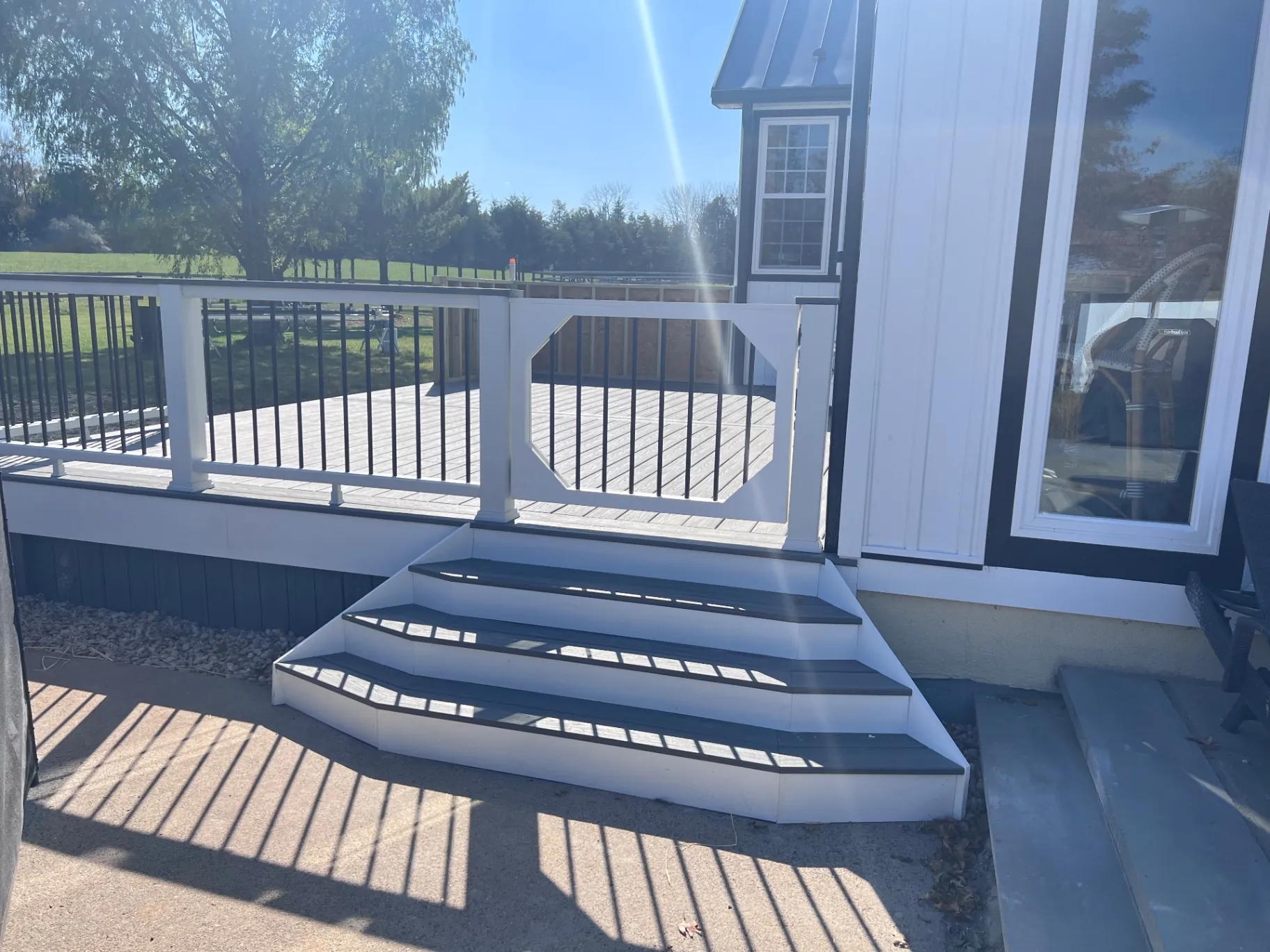 Gray composite deck with flared stairs in Lower Makefield, PA