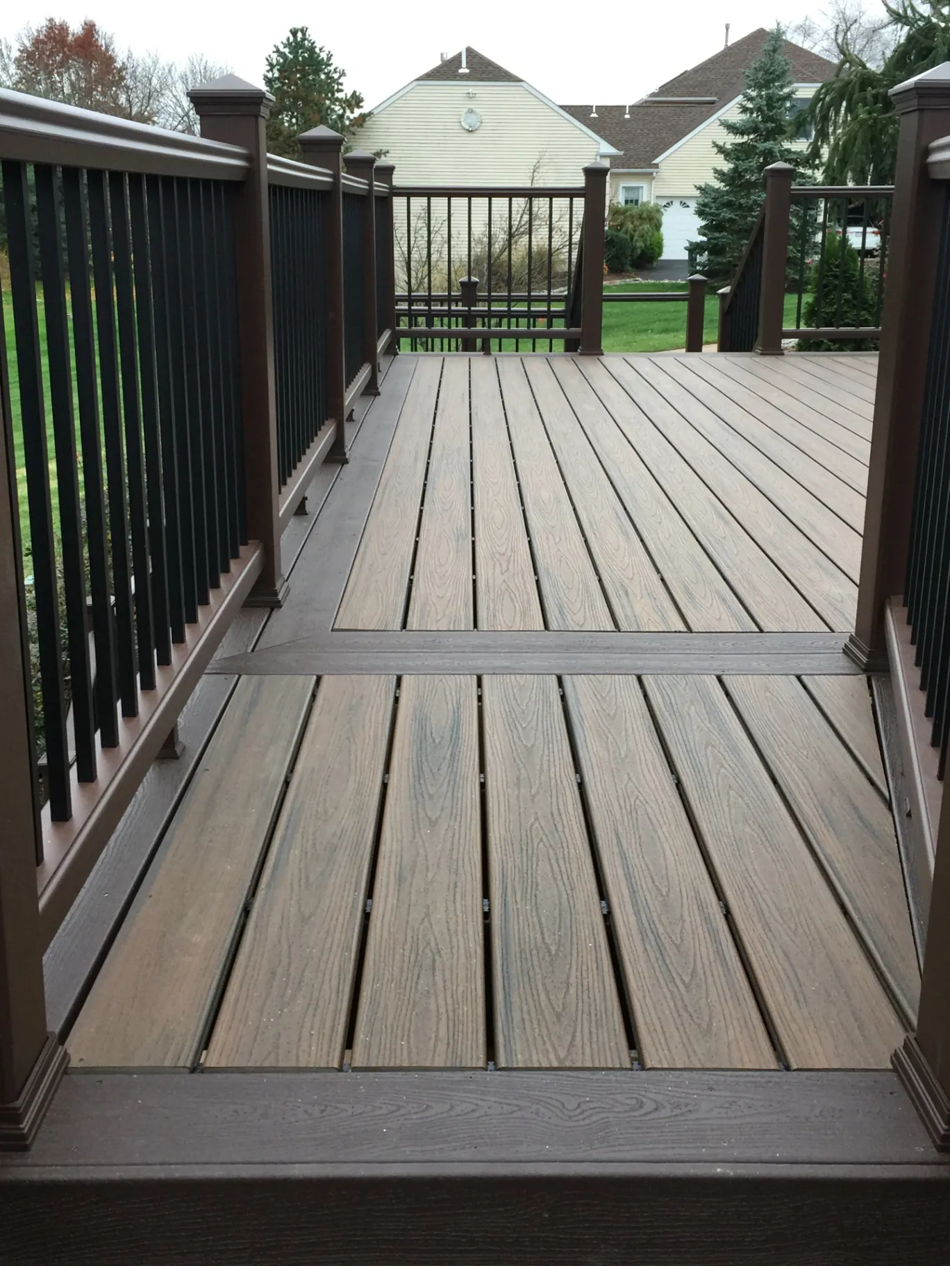 Brown composite deck with dark railings in Avalon, NJ
