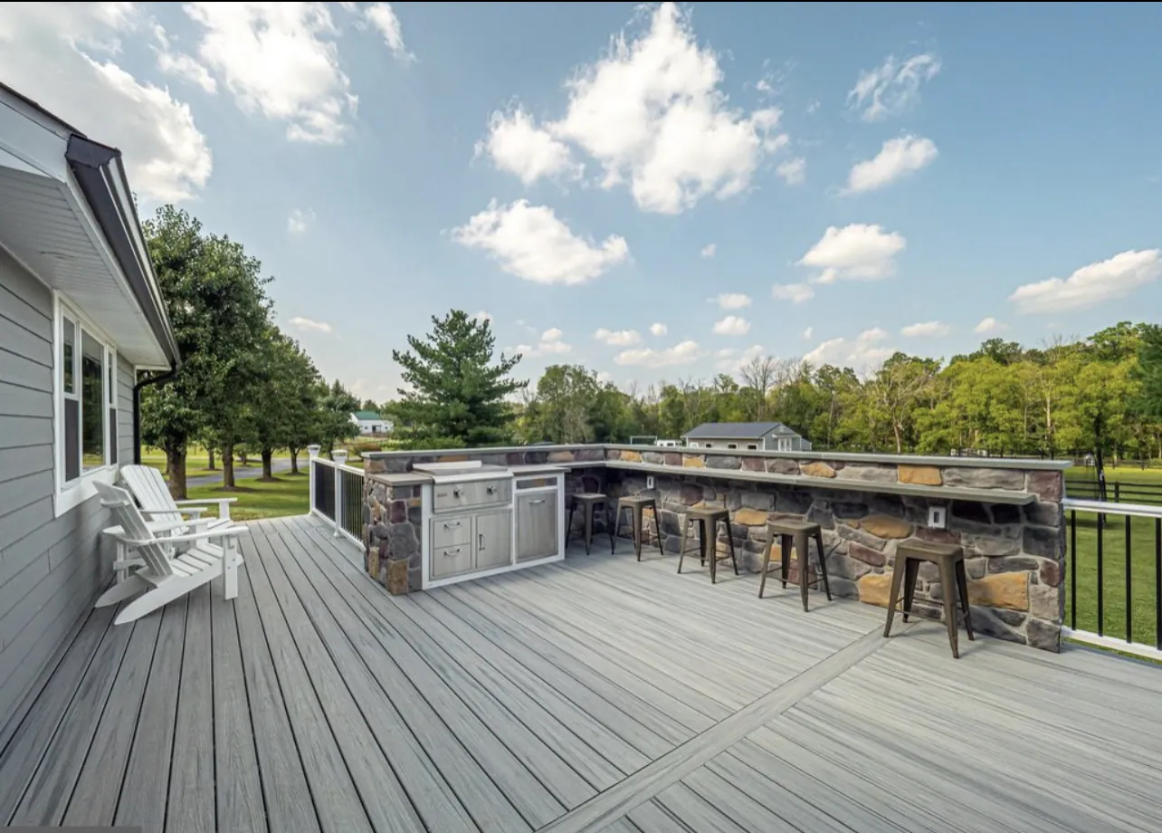 Composite deck with fieldstone outdoor kitchen in Doylestown, PA