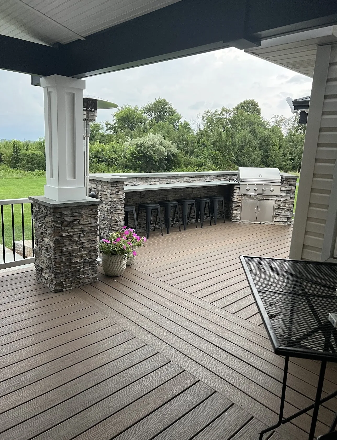 Covered composite deck with stone outdoor kitchen in Southampton, PA